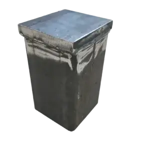 A 4x4 Post Driving Cap with a metal, rectangular form and fitted lid, showing a slightly weathered surface, isolated on a white background.