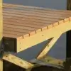 Close-up of a Maine dock corner over calm water, showing wet and dry wood planks with sturdy 4x4 Post Brackets supporting the beams underneath.
