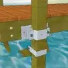 Close-up of a wooden dock secured with 4x4 Post Brackets to vertical posts above blue water, by Great Northern Docks in Maine.