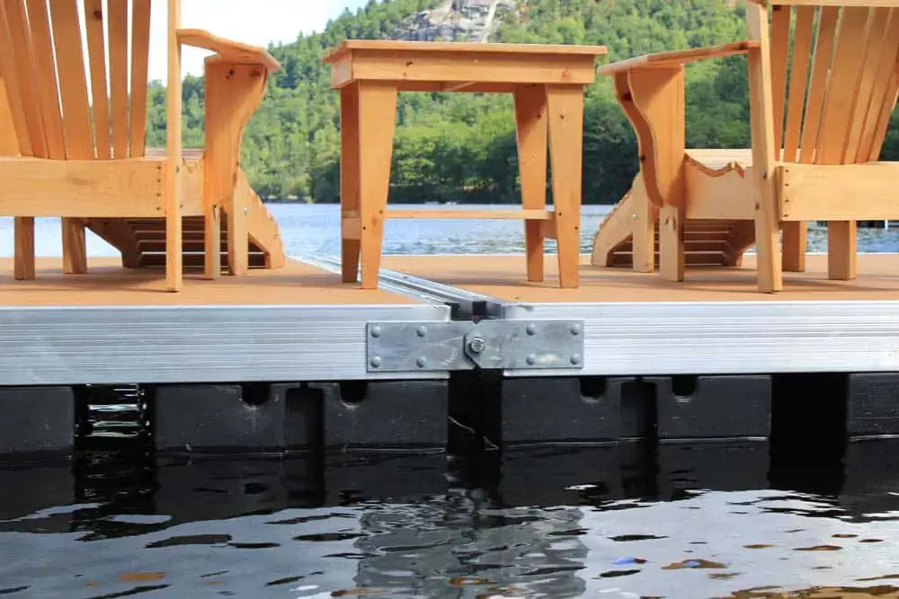 Eight Dock Hinge Bolts with Nylock Nuts by Great Northern Docks secure a Maine dock on a lake, ensuring durability and showcasing expert craftsmanship.