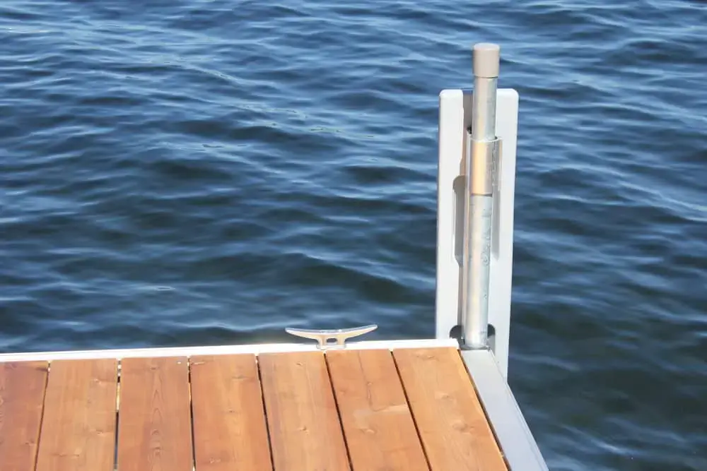 A Guardian Bumper with Pipe Bracket from Great Northern Docks extends over calm, rippling blue Maine water.