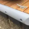 The Guardian Bumper, in gray, attaches to the edge of a wood dock with a metal cleat—ideal for Maine docks with sand below.