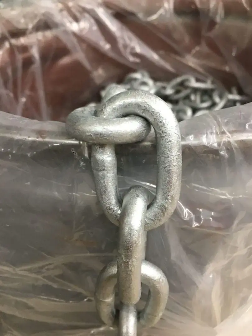 A close-up of the Chain draped over a container lined with clear plastic, similar to hardware seen on Great Northern Docks in Maine.