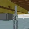 A close-up of a dock’s underside featuring the Anchor Plate Keyhole, with a chain hanging down and a metal ladder descending into the water.