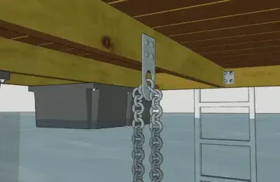 A close-up of a dock’s underside featuring the Anchor Plate Keyhole, with a chain hanging down and a metal ladder descending into the water.