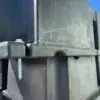 Close-up of Dock Float Attachment Kit (Foam Filled) with stacked black containers and a silver screw, outdoors under a blue sky at Great Northern Docks.