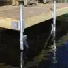 Close-up of Maine docks with metal supports in water, featuring a chair atop the dock secured with the Galvanized Carriage Bolt Attachment Kit.