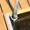 Close-up of a Maine Docks corner with Post Guides, metal supports, and hardware over clear, shallow water.