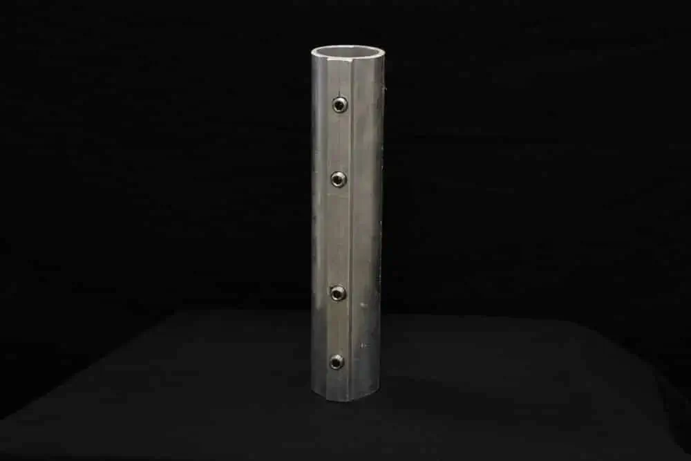 The Jack Pole Extension is a vertical aluminum tube with evenly spaced round holes, shown upright against a black background.