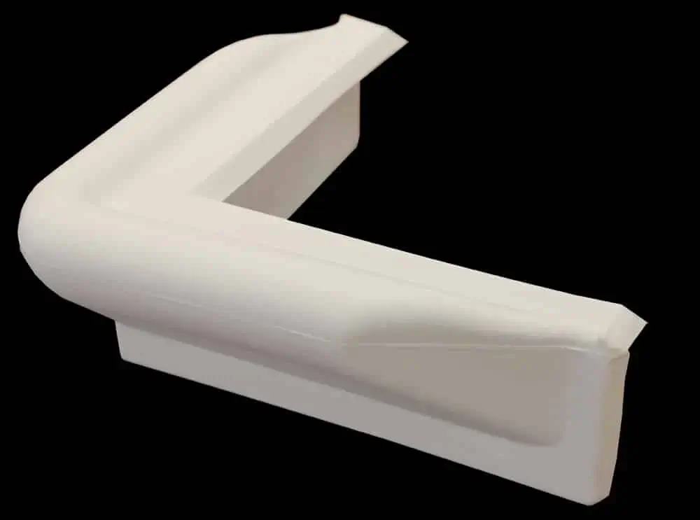 The white Corner Bumper cushions sharp edges on Aluminum Docks and is shown against a black background.