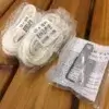 Two coiled Mooring Whip (2 Pack) ropes, a metal bracket, and an instruction sheet are displayed on wood. Ropes are labeled 1/4 x 12 FT.