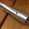 A Mooring Whip (2 Pack) with a side screw, commonly used for Aluminum Docks, sits on a wood surface showing its grain lines.