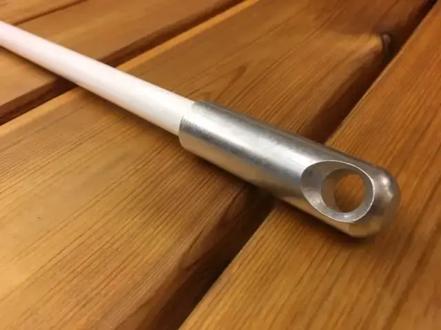 A white Mooring Whip (2 Pack) with a metal-tipped large hole lays diagonally on wood, reflecting classic Maine dock craftsmanship.