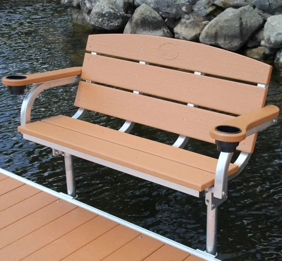 Swim Raft with cup holders on each armrest, placed on a Great Northern Docks wood dock above water, rocks in the background.
