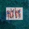 swim_platform-low Five women in swimsuits relax on a Swim Raft - Connect-A-Dock, floating on clear blue-green water, seen from above.